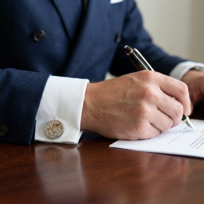 Rolex Watch Cufflinks - 1600 Calibre - Cellini worn on the cuff – navy double breasted suit signing contract